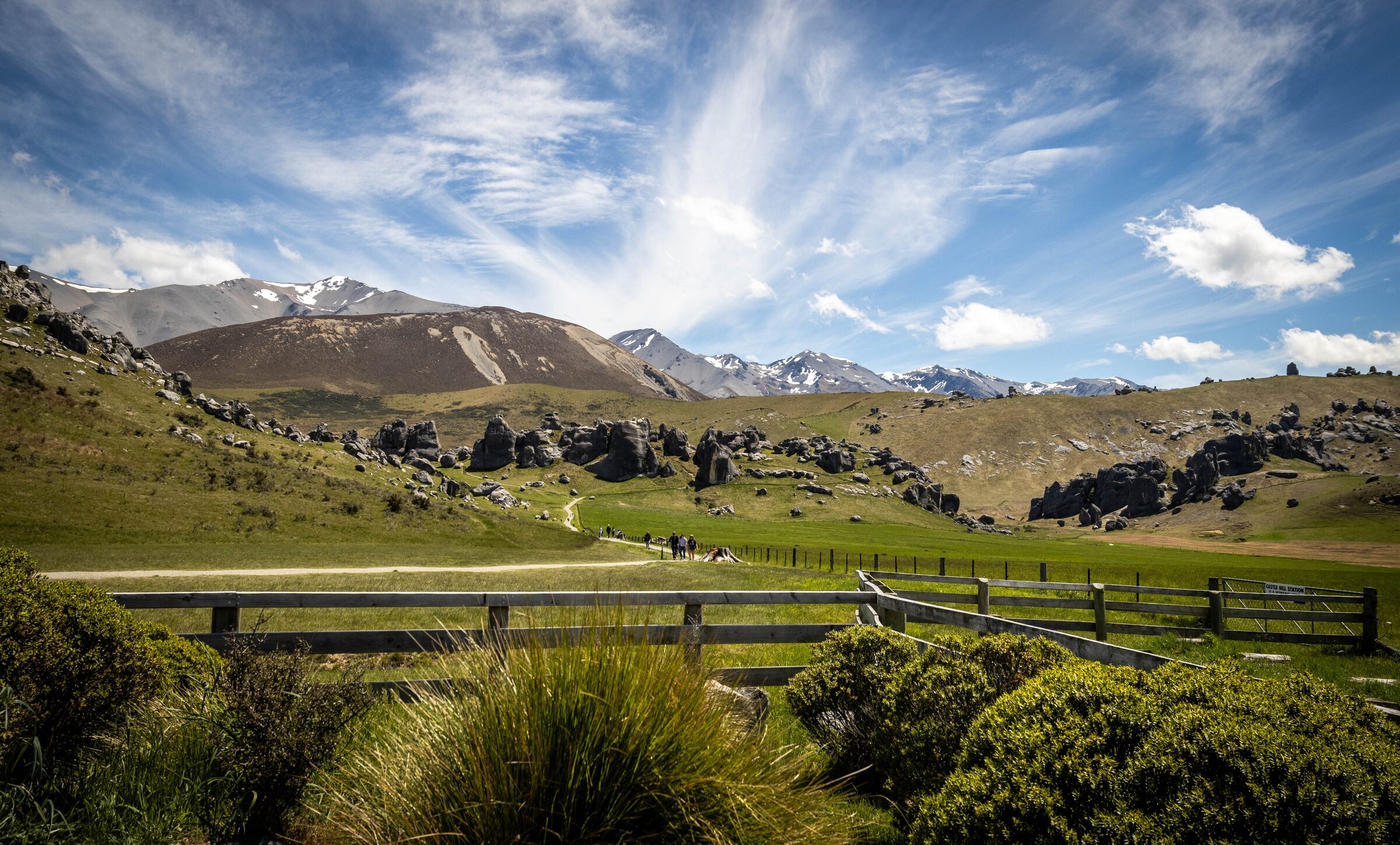 Wide view of Castle Hill Station's limestone tors and hills under a dramatic sky