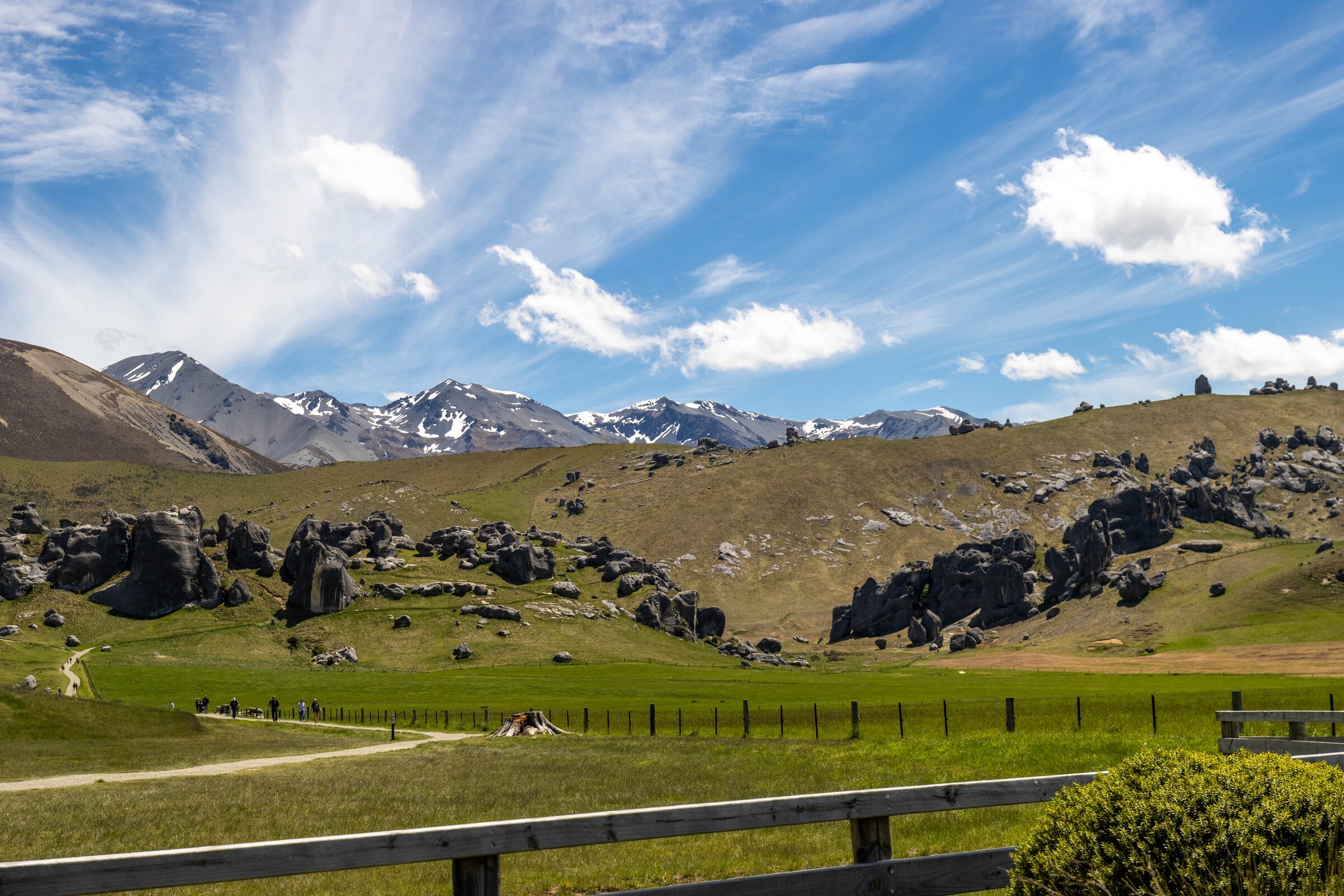 Limestone boulder formations at Kura Tāwhiti / Castle Hill, with snow-capped mountains behind